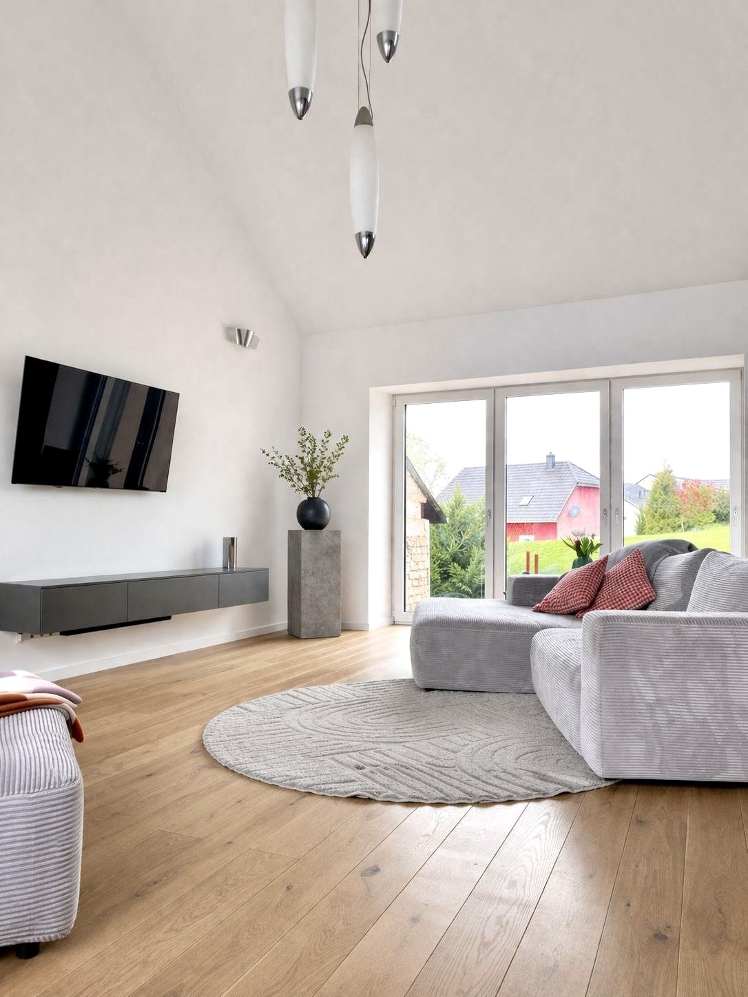 Helles Wohnzimmer mit Bodentiefen Fenstern und Parkettboden